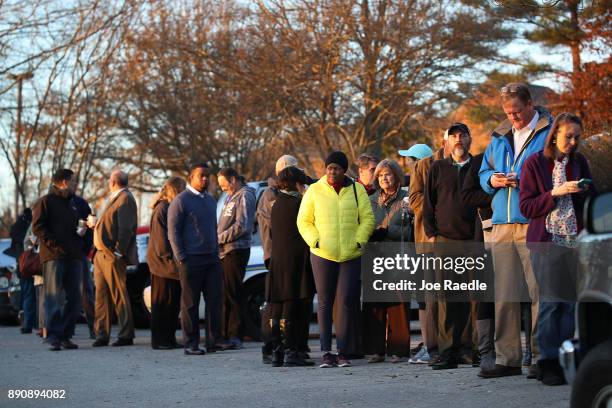Voters wait in line to cast their ballot at a polling station setup in the St Thomas Episcopal Church on December 12, 2017 in Birmingham, Alabama....