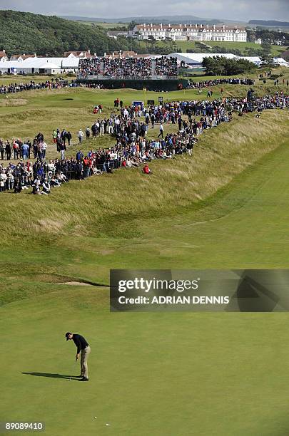 English golfer Ross Fisher putts on the 7th green, on the third day of the 138th British Open Championship at Turnberry Golf Course in south west...