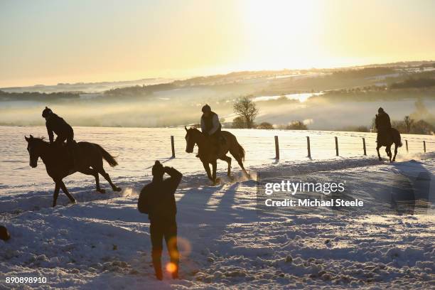 Assistant trainer Carl Llewellyn looks on as the second lot workout during morning gallops at the yard of national hunt trainer Nigel Twiston-Davies...