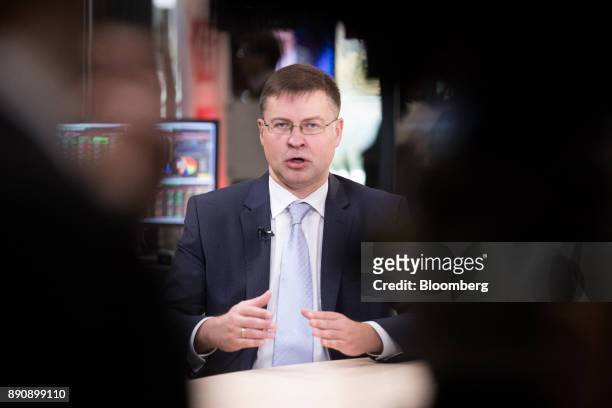 Valdis Dombrovskis, vice president of the European Commission, gestures while speaking during a Bloomberg Television interview at the One Planet...