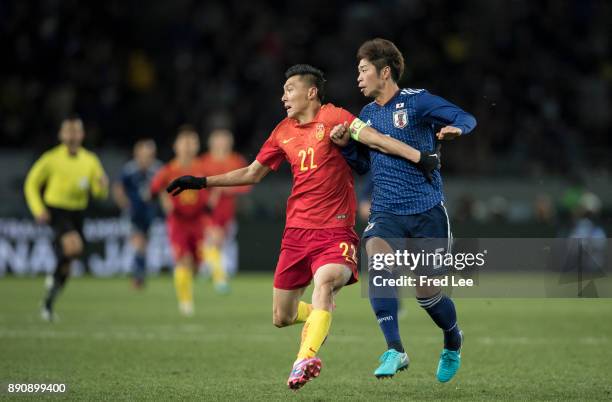 Yu dabao of china and MIURA Genta of Japan in action during the EAFF E-1 Men's Football Championship between Japan and China at Ajinomoto Stadium on...