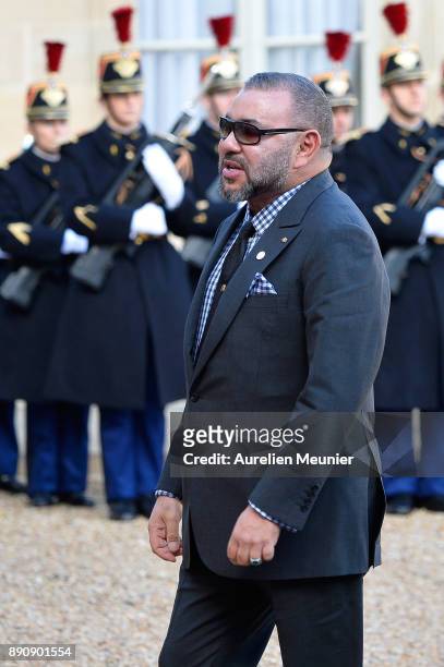 Mohammed VI of Morocco arrives for a meeting with French President Emmanuel Macron as he receives the One Planet Summit's international leaders at...