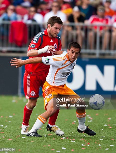 Defender Jim Brennan of the Toronto FC fights for the ball with Danny Cruz of the Houston Dynamo during the match at BMO Field on July 18, 2009 in...