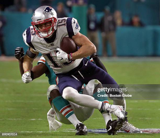 New England Patriots wide receiver Chris Hogan tries for extra yardage after making this pass reception during the second half of a game against the...