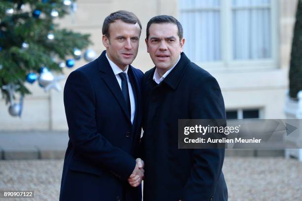 French President Emmanuel Macron welcomes Prime Minister of Greece Alexis Tsipras as he arrives for a meeting for the One Planet Summit's...