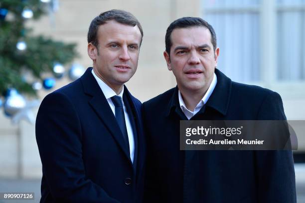 French President Emmanuel Macron welcomes Prime Minister of Greece Alexis Tsipras as he arrives for a meeting for the One Planet Summit's...