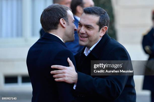 French President Emmanuel Macron welcomes Prime Minister of Greece Alexis Tsipras as he arrives for a meeting for the One Planet Summit's...