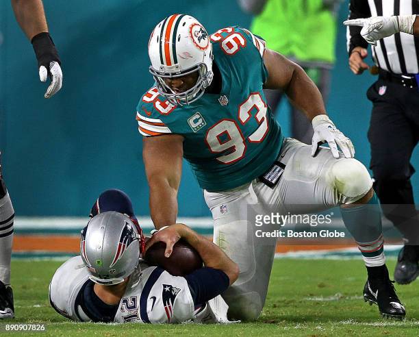 Miami Dolphins defensive tackle Ndamukong Suh sacks New England Patriots quarterback Tom Brady during the fourth quarter of a game at the Hard Rock...