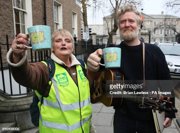 Oscar winning Singer Glen Hansard with a cup saying 'Home Sweet Home' given to him by homeless campaigner Sheila O'Byrne ahead of his performance at...