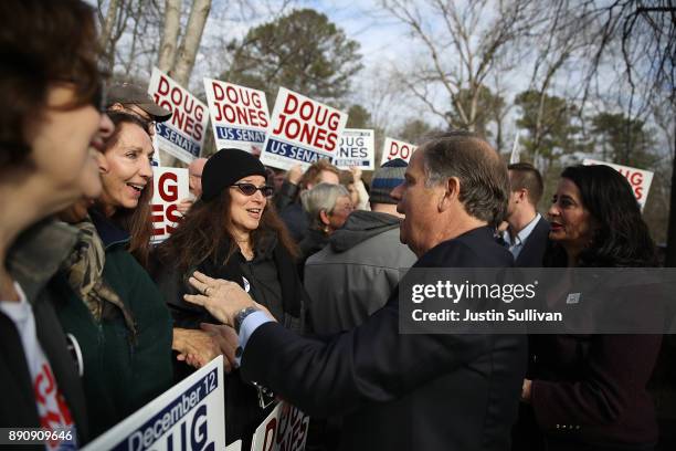 Democratic senatorial candidate Doug Jones greets supporters after voting at Brookwood Baptist Church on December 12, 2017 in Mountain Brook,...