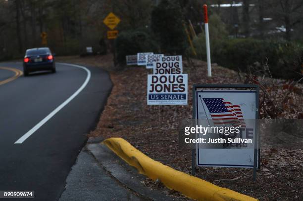 Campaign signs for democratic senatorial candidate Doug Jones are displayed outside of a polling station at Brookwood Baptist Church on December 12,...