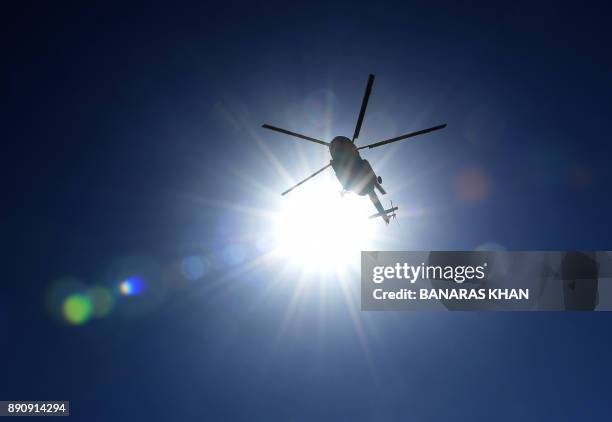 Pakistani anti-narcotics force helicopter fly over the drugs burning ceremony in Quetta on December 12, 2017. More than 45 percent of Afghanistan's...