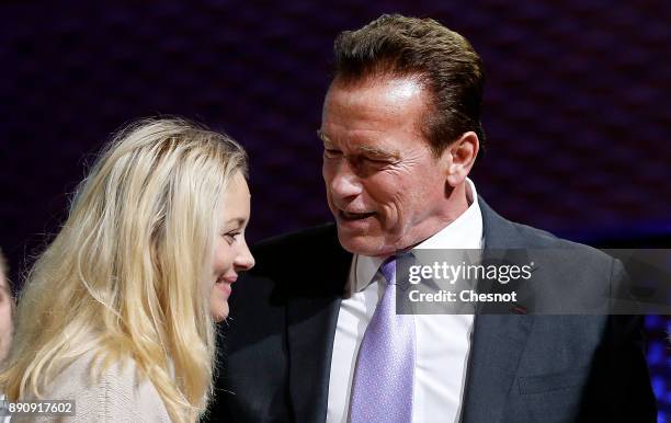 French actress Marion Cotillard speaks with R20 Founder and former California state governor Arnold Schwarzenegger at the end of a working session...