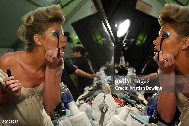 Model prepares backstage at the Ed Hardy Swimwear 2010 fashion show during Mercedes-Benz Fashion Week Swim at the Cabana Grande at The Raleigh on...