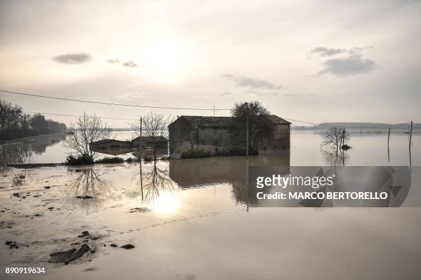 This photo taken on December 12, 2017 in Brescello shows a flooded area after the Enza river broke its banks, following heavy rain throughout the...