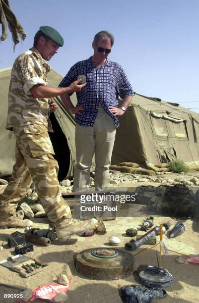 British Defense Secretary Geoff Hoon is shown mines encountered by coalition troops in Afghanistan during his visit with Royal Marines from 45...