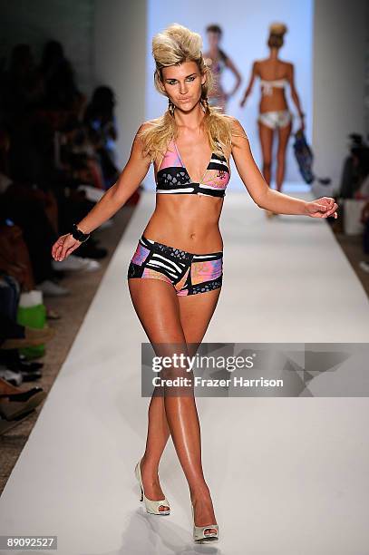 Model walks the runway at the Ed Hardy Swimwear 2010 fashion show during Mercedes-Benz Fashion Week Swim at the Cabana Grande at The Raleigh on July...