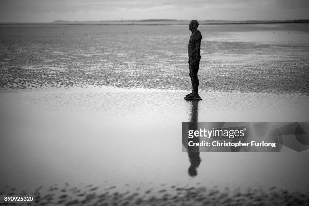 Statue at Antony Gormley's art installation 'Another Place' at Crosby Beach stands in the sand on November 12, 2017 in Liverpool, England.