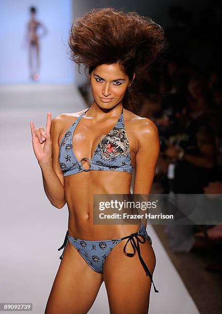 Model walks the runway at the Ed Hardy Swimwear 2010 fashion show during Mercedes-Benz Fashion Week Swim at the Cabana Grande at The Raleigh on July...