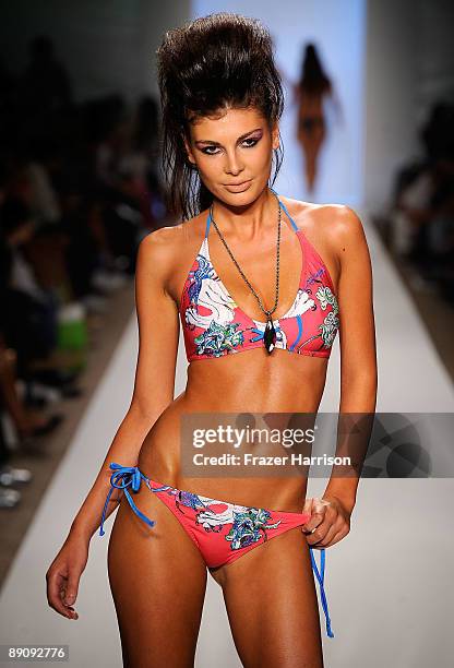 Model walks the runway at the Ed Hardy Swimwear 2010 fashion show during Mercedes-Benz Fashion Week Swim at the Cabana Grande at The Raleigh on July...