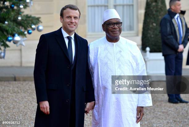 French President Emmanuel Macron welcomes President of Mali, Ibrahim Boubacar Keita as he arrives for a meeting for the One Planet Summit's...