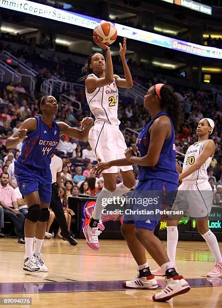 DeWanna Bonner of the Phoenix Mercury puts up a shot over Taj McWilliams and Kara Braxton of the Detroit Shock during the WNBA game at US Airways...
