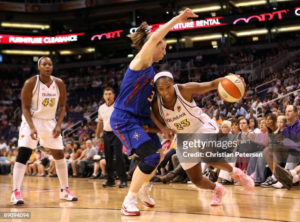 Cappie Pondexter of the Phoenix Mercury attempts to drive the ball around Katie Smith of the Detroit Shock during the WNBA game at US Airways Center...