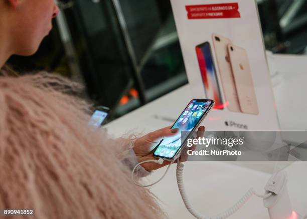 Girl tries new Apple product at its promoting table at one of shopping malls in Kyiv, Ukraine, Dec.12, 2017. IPhone X official sales started in...
