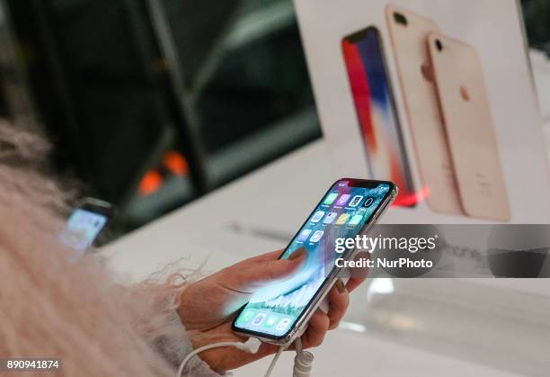 Girl tries new Apple product at its promoting table at one of shopping malls in Kyiv, Ukraine, Dec.12, 2017. IPhone X official sales started in...