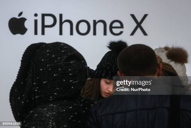 Girl stays near the Apple promoting table at one of shopping malls in Kyiv, Ukraine, Dec.12, 2017. IPhone X official sales started in Ukraine.