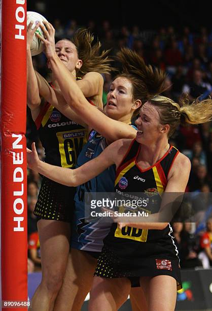Casey Williams of the Magic , Kate Beveridge of the thunderbirds and Jodi Tod of the Magic contest for the rebound during the ANZ Championships...