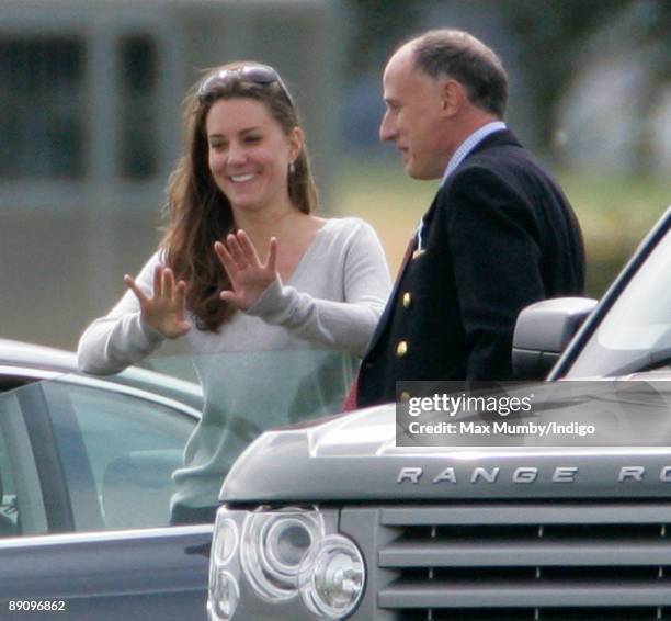 Kate Middleton leans on Prince William's Audi A5 car as she talks with Jamie Lowther-Pinkerton whilst they watch Prince's William and Harry play in...