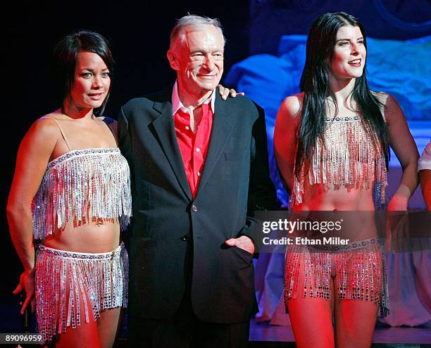 Dancers Carolyn Pace and and Olivia Cipolla bring Playboy founder Hugh Hefner onstage during the adult production, "PEEPSHOW" starring his former...