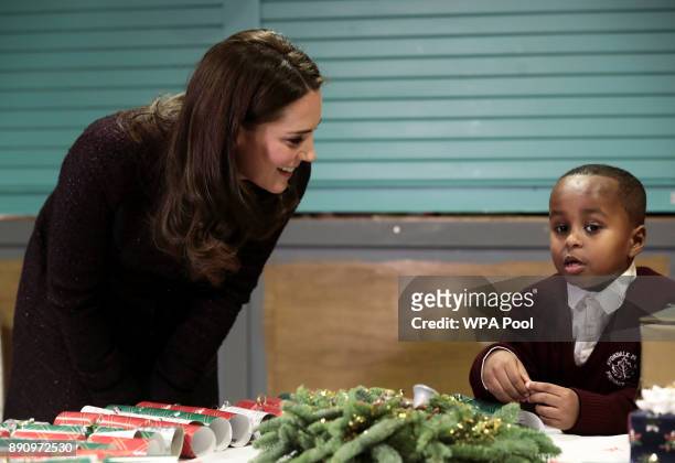 Britain's Catherine, Duchess of Cambridge speaks to Yahya Hussein Ali, 7 who was affected by the Grenfell Tower fire, during a visit to the Rugby...
