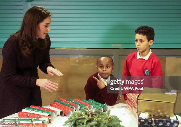 Britain's Catherine, Duchess of Cambridge speaks to Yahya Hussein Ali and Dawud Wahabi children affected by the Grenfell Tower fire, during a visit...