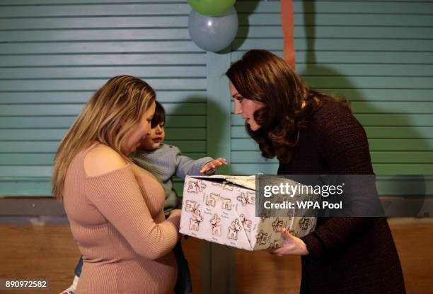 Britain's Catherine, Duchess of Cambridge speaks to children, during a visit to the Rugby Portobello Trust's Christmas party which included children...