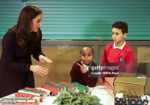 Catherine, Duchess of Cambridge speaks to Yahya Hussein Ali, 7 and Dawud Wahabi children affected by the Grenfell Tower fire, at its community centre...