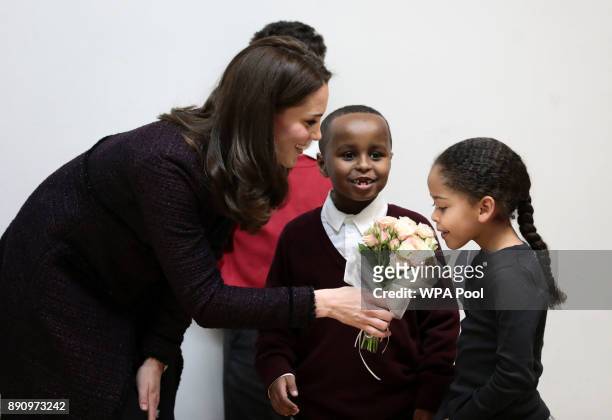Catherine, Duchess of Cambridge speaks to Yahya Hussein Ali and Dawud Wahabi children affected by the Grenfell Tower fire, and Ailise Taylor during a...