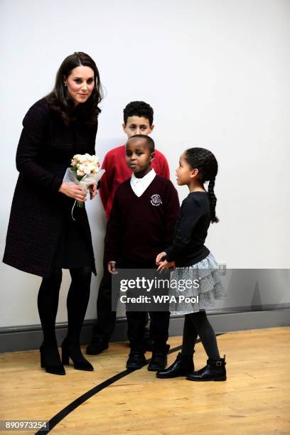 Catherine, Duchess of Cambridge speaks to Yahya Hussein Ali and Dawud Wahabi children affected by the Grenfell Tower fire, at its community centre in...