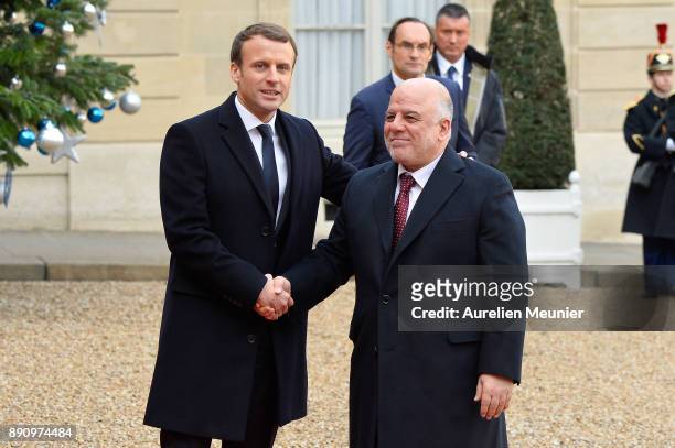 French President Emmanuel Macron welcomes Prime Minister of Irak Haider al-Abadi as he arrives for a meeting for the One Planet Summit's...