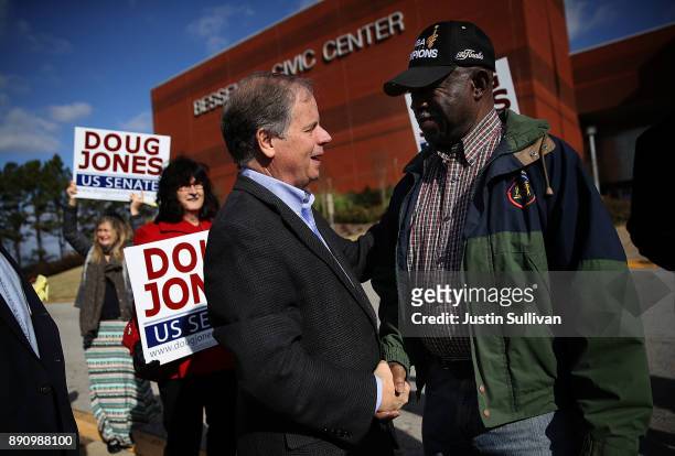 Democratic Senatorial candidate Doug Jones greets voters outside of a polling station at the Bessemer Civic Center on December 12, 2017 in Bessemer,...