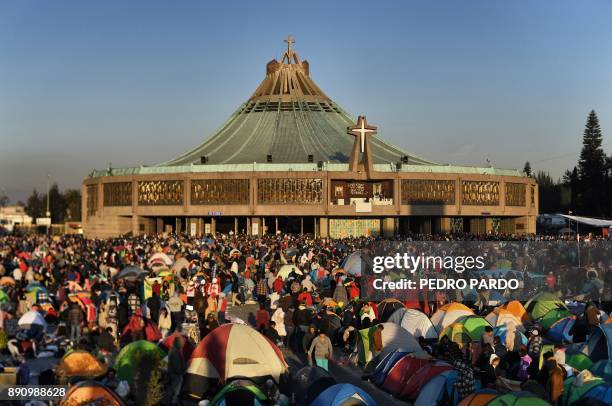 People gather around the Guadalupe Basilica during the feast of the Virgin of Guadalupe, patron saint of Mexico in Mexico City on December 12, 2017....