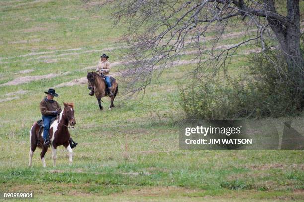 Republican Senatorial candidate Roy Moore and his wife Kayla ride their horses to the polling station to vote in Gallant, Alabama, on December 12,...