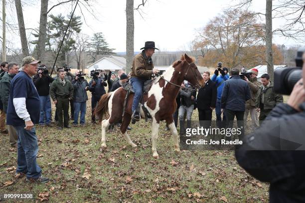 Republican Senatorial candidate Roy Moore rides his horse after casting his vote at the polling location setup in the Fire Department on December 12,...