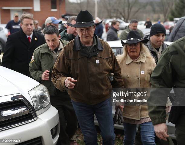 Republican Senatorial candidate Roy Moore and his wife Kayla Moore leave after casting their votes at the polling location setup in the Fire...