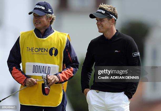 English golfer Luke Donald stands with his caddy on the 1st green, on the final day of the 138th British Open Championship at Turnberry Golf Course...