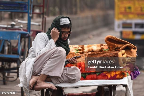 Vendor sells blankets on a roadside on a cold day, on December 12, 2017 in New Delhi, India.