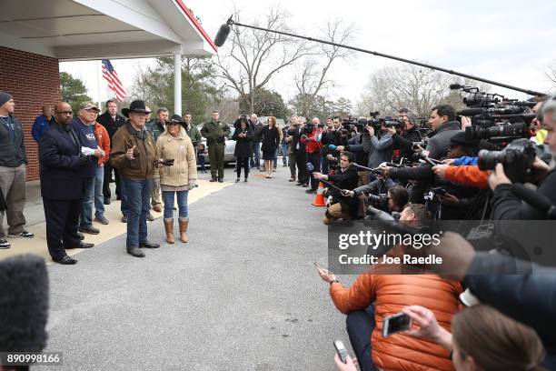 Republican Senatorial candidate Roy Moore and his wife Kayla Moore speak to the media after they leave the polling location setup in the Fire...