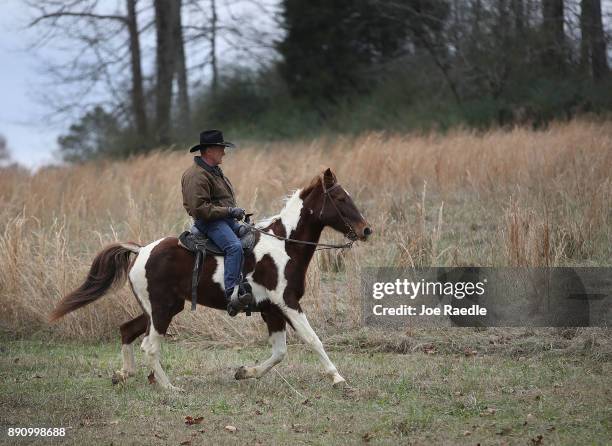 Republican Senatorial candidate Roy Moore rides his horse to cast his vote at the polling location setup in the Fire Department on December 12, 2017...