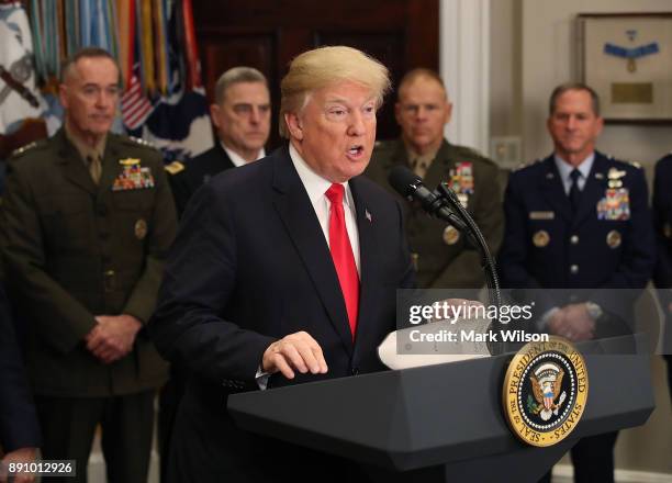 President Donald Trump speaks before signing the H.R. 2810, National Defense Authorization Act for fiscal year 2018, in the Roosevelt Room at the...